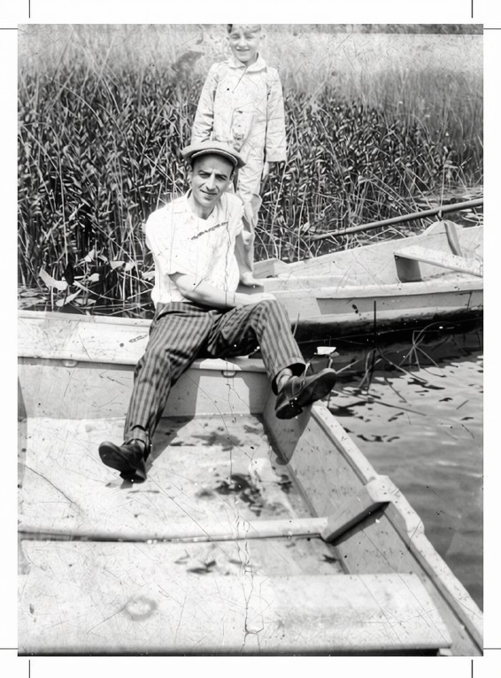 Back and White photos of Man sitting in boat.